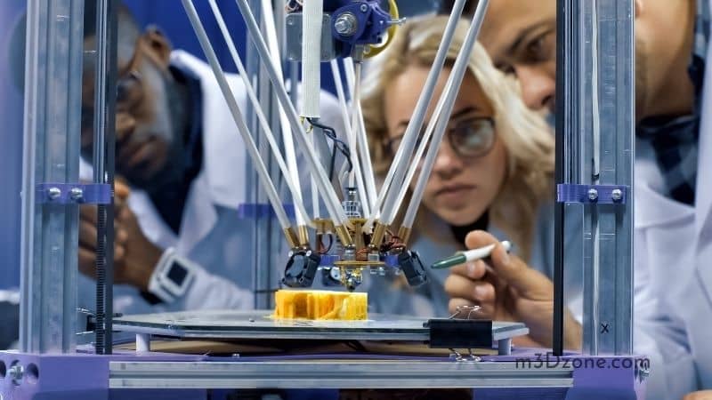 Researchers Watching 3D Printer In Process